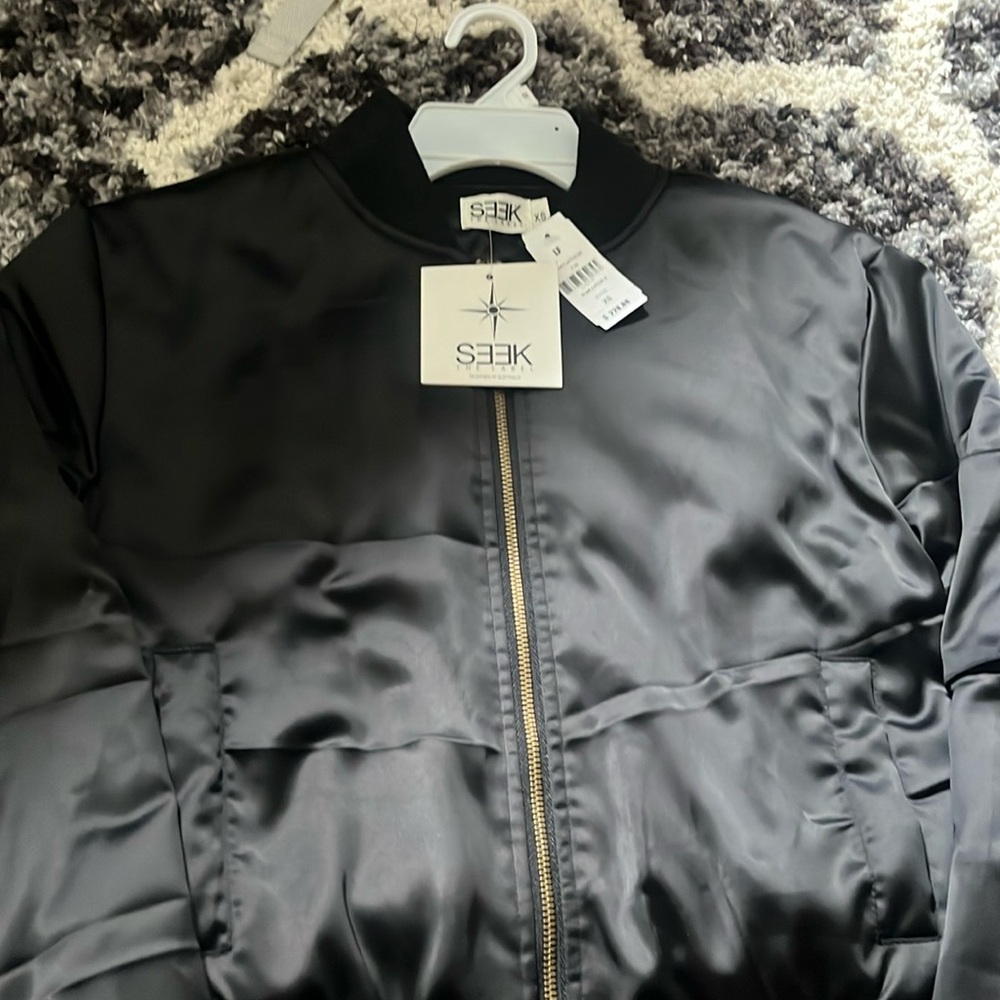 A beautiful black jacket with gold acents. Brand is Seek It’s an XS size.!